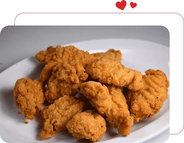 A plate of fried chicken on top of a table.